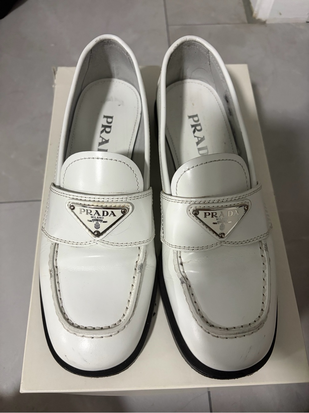 Prada White Leather Loafers with Silver Logo Plaque